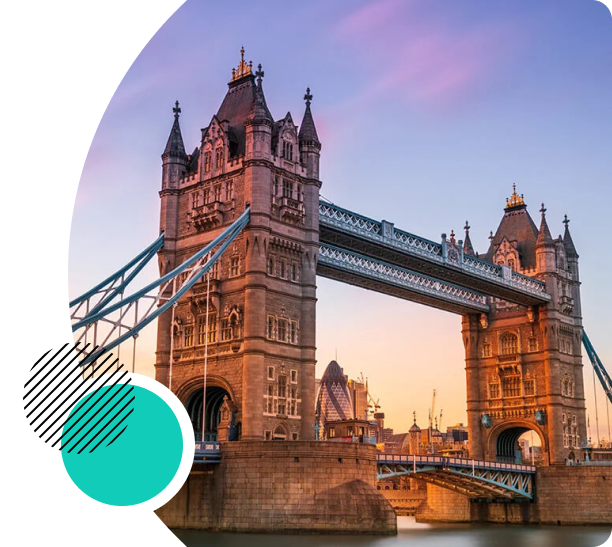 Iconic view of Tower Bridge in London at sunset, with the bridge's towers lit against the sky.