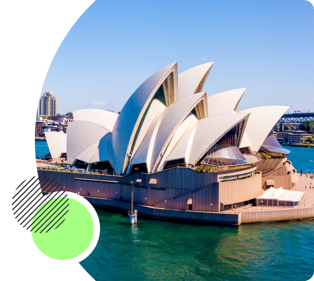 The Sydney Opera House, with its famous sail-like architecture, set against a clear blue sky and the surrounding harbor.